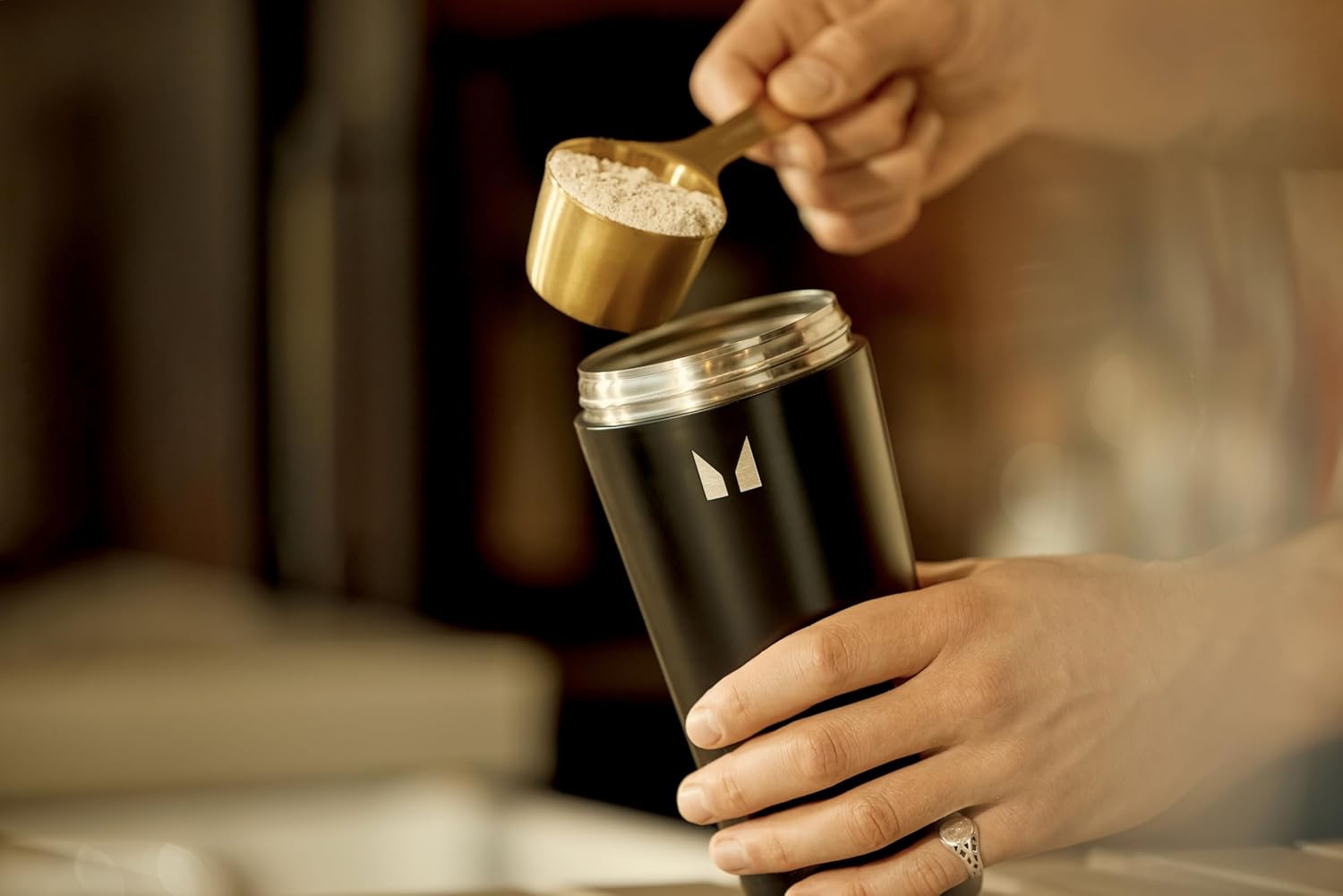 How to Use: MyProtein Vanilla Whey Protein powder being mixed in a shaker bottle.