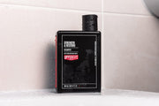 Lifestyle/use image: Uppercut Deluxe Strength and Restore Shampoo 240ml men hair care routine