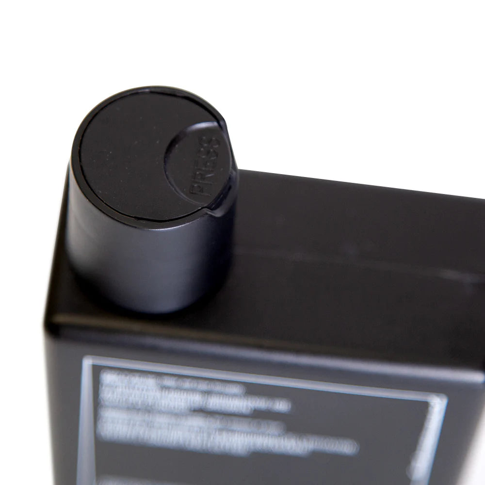 Side image: Uppercut Deluxe Detox and Degrease Shampoo 240ml bottle charcoal formula packaging