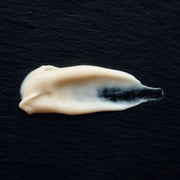 White cream smear on a black background